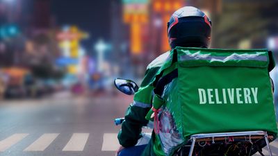 A delivery driver riding a motorcycle